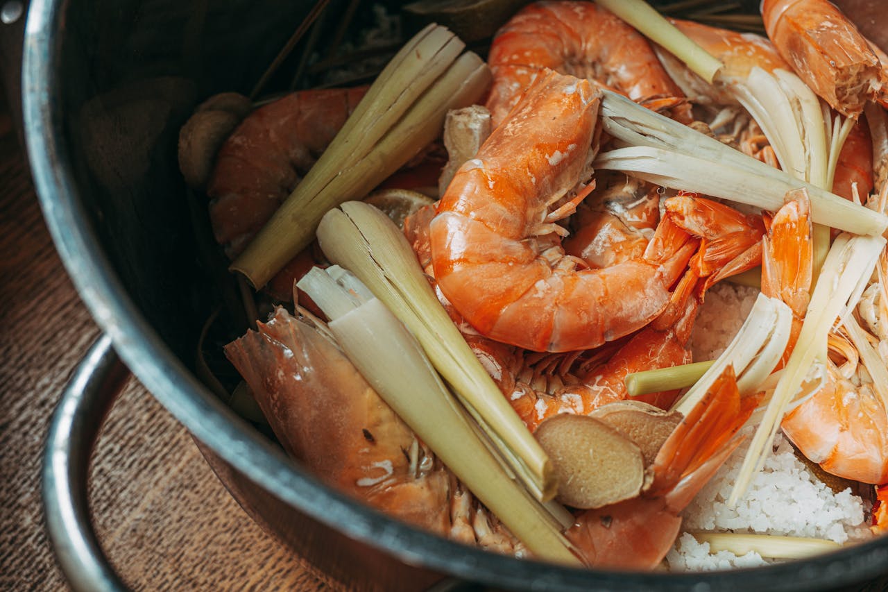 Preparation of flavorful shrimp soup with lemongrass in a pot.